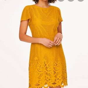 Mustard yellow loft dress with floral design on the bottom.